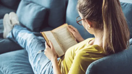 Woman reading on couch 5 books for freelancers