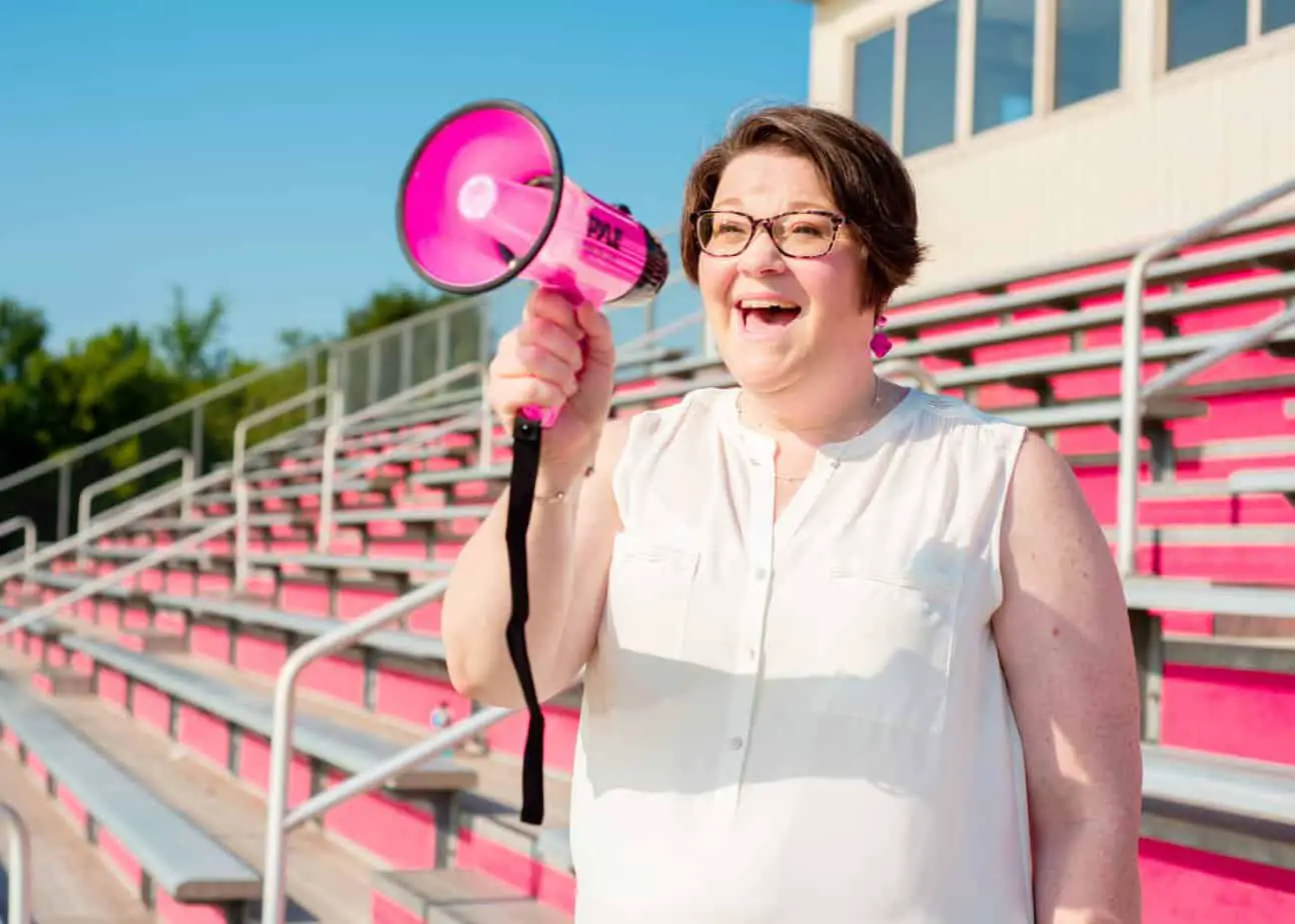 Tonya Lawson standing in a stadium speaking into a hot pink megaphone about 1-on-1 coaching