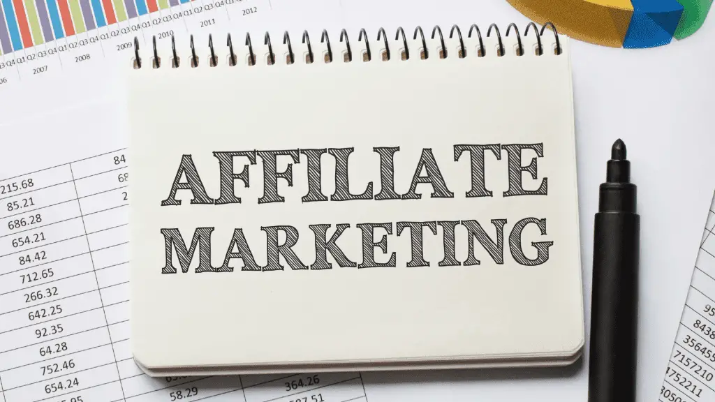 notebook that says affiliate marketing for beginners and has a black pen next to it.