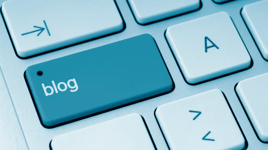 Image for article on blogging for creatives shows a teal computer keyboard displaying a key that says blog
